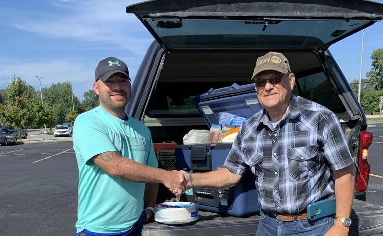 Scott Blish receiving his cooler and picnic package from Karl Iloncai